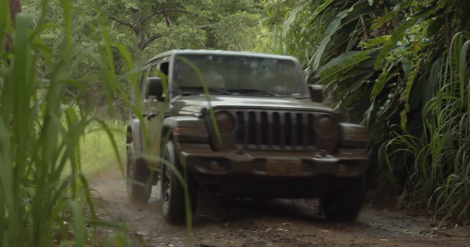 A jeep plows through the mud