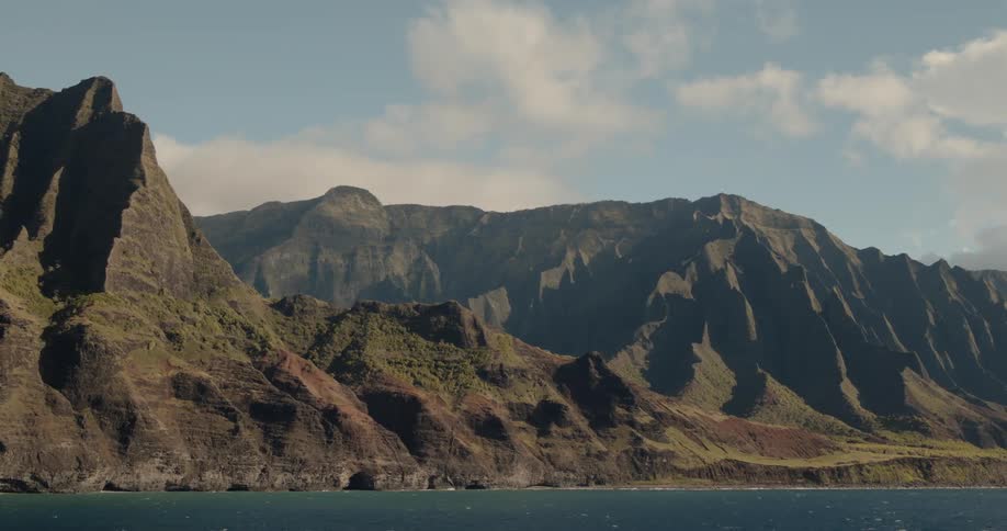 Clouds float above coastal mountains