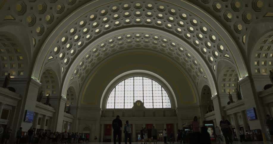 People walk in the large dark terminal