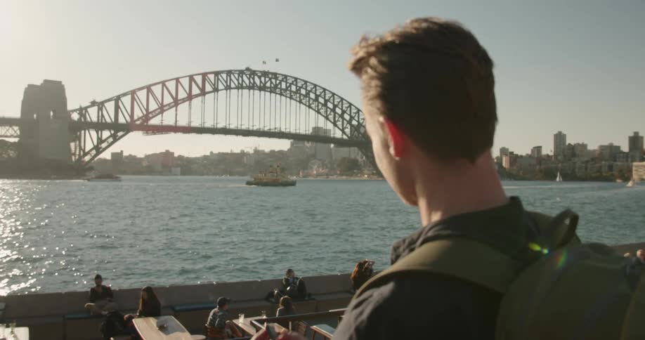 Man takes a photo of a bridge with his cellphone