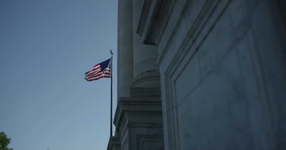 The flag moves in the air above the building