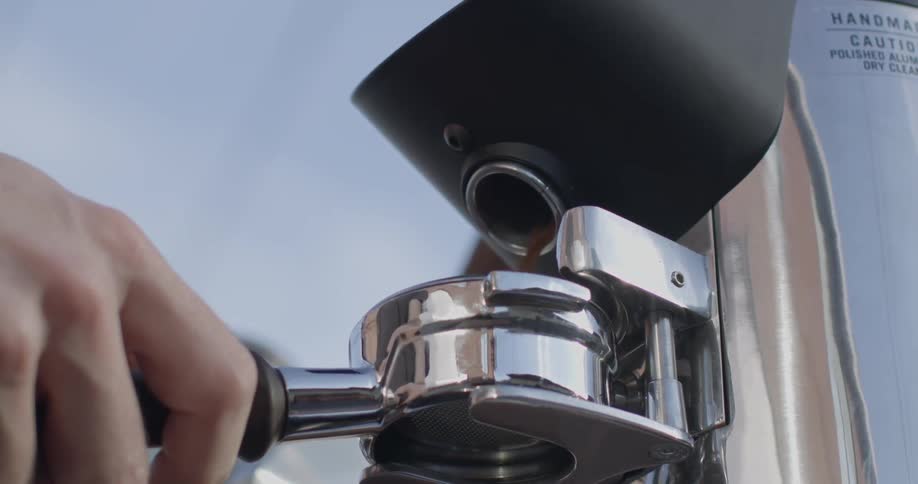Coffee grounds are crushed in a machine