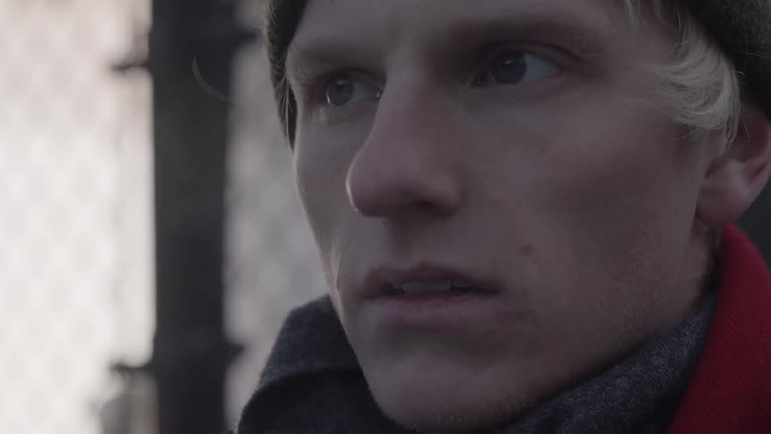 A man's breath is visible on a cold day