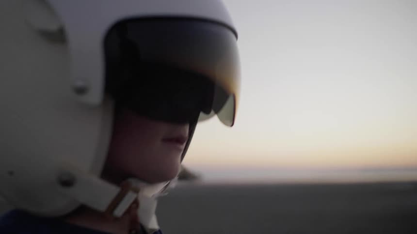 A young boy plays with a helmet on