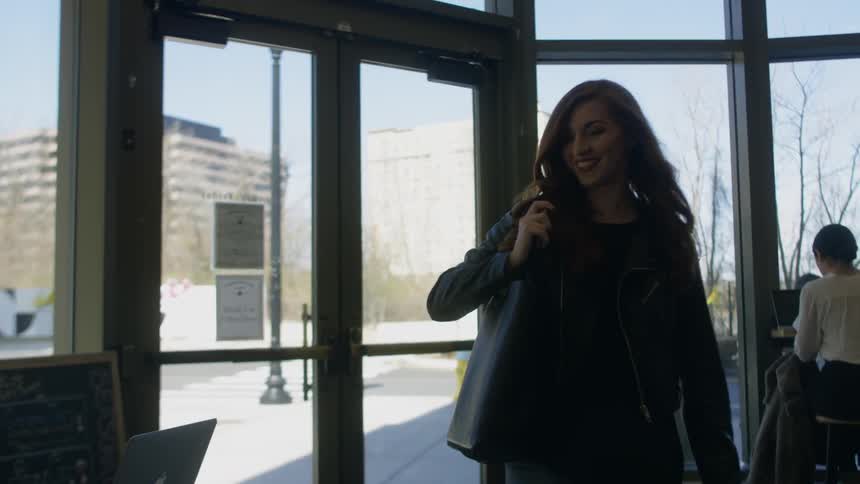 A woman enters a coffee shop