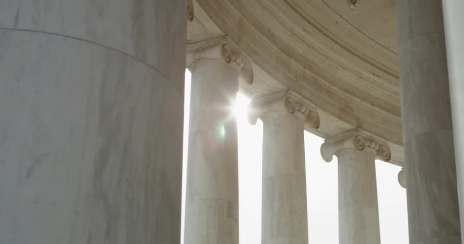 Sun shining through pillars of Jefferson Memorial in Washington DC
