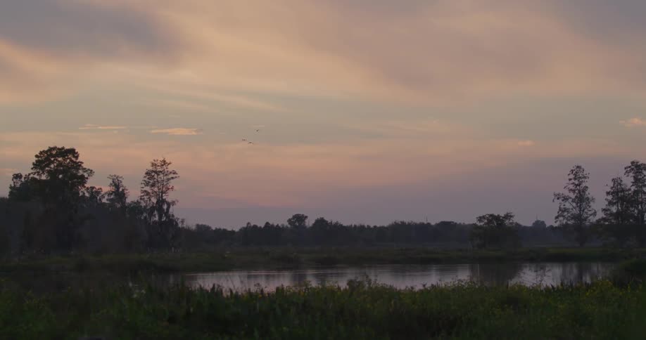 The sun is setting over the lake
