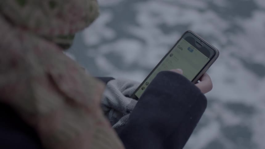 A person is checking their phone outside
