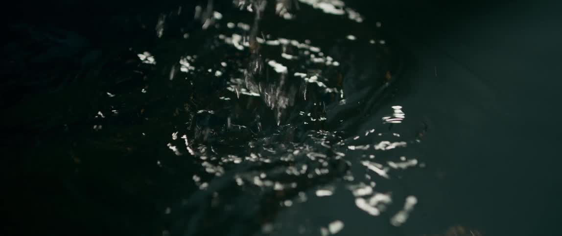 A person raises their hand out of the water