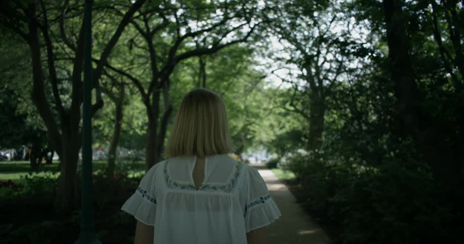 Woman walks in a park