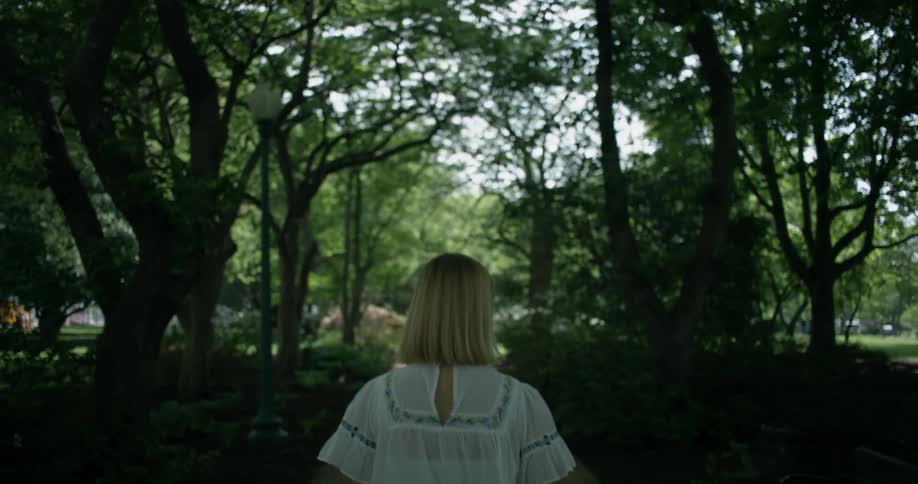 Woman walks in a park