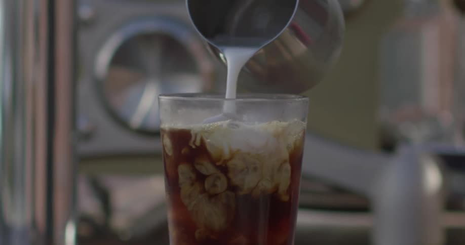 Milk is poured into a beverage