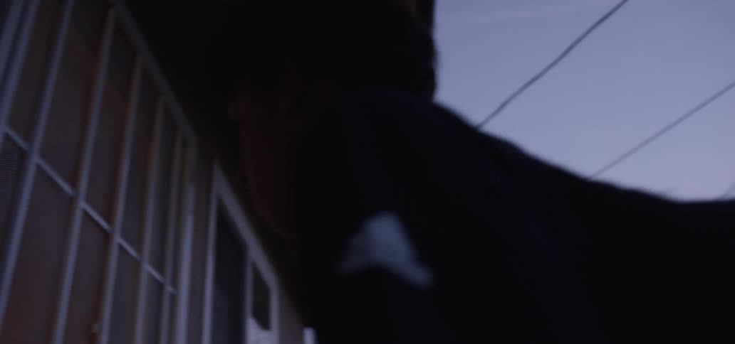 The boy walks over and enters the house