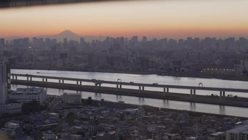 Cars travel over the bridge near the city