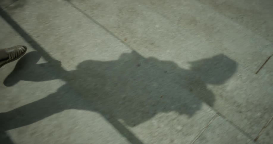 A person is giving off a shadow as they climb down the steps