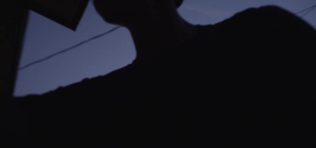 The child walks and opens the door to his home at dawn