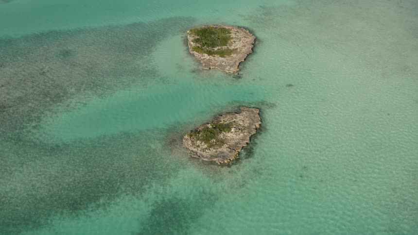 Two small islands are in the green water