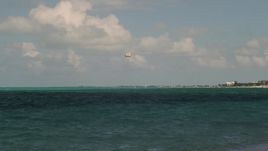Parachute above a large body of water