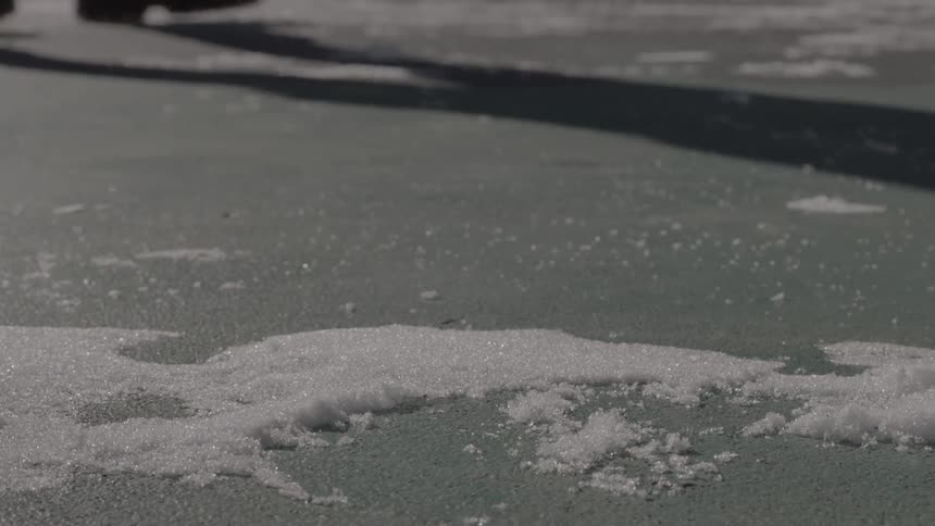 A person is casting a shadow on the ground outside in winter