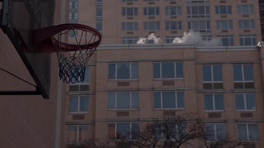 Steam rises off the roof past the basketball hoop