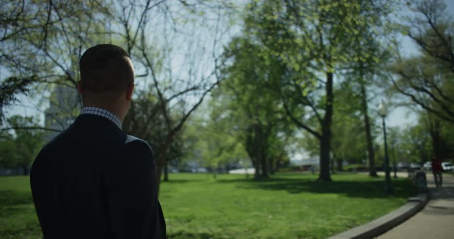 A man walks on a trail on a sunny day