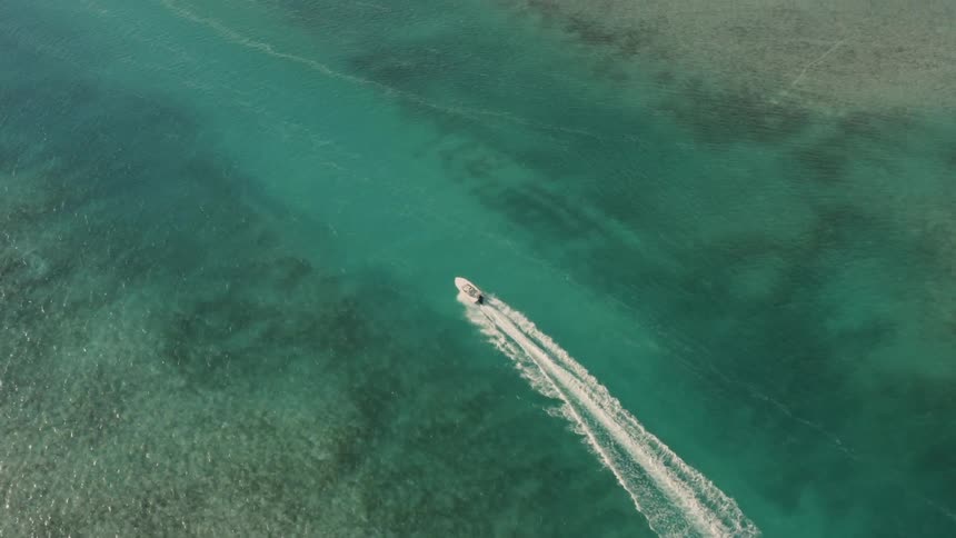 Boat creates waves as it travels through the water