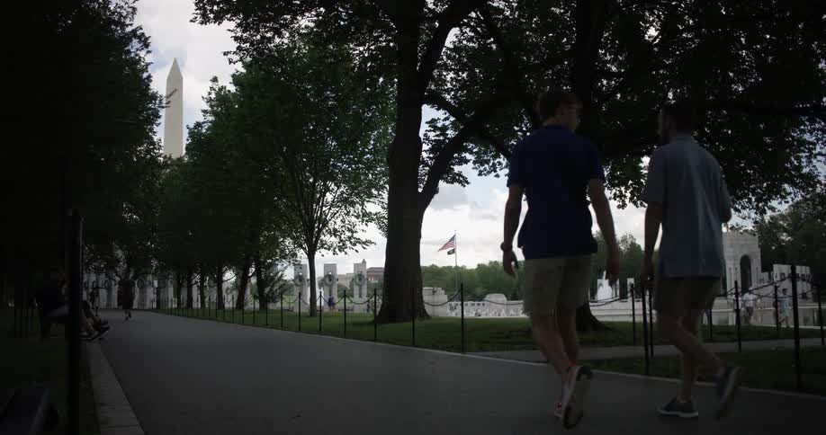 Two men walk on the trail towards the washington monument