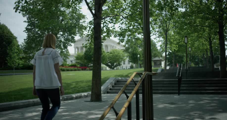 A woman ascends stairs outside