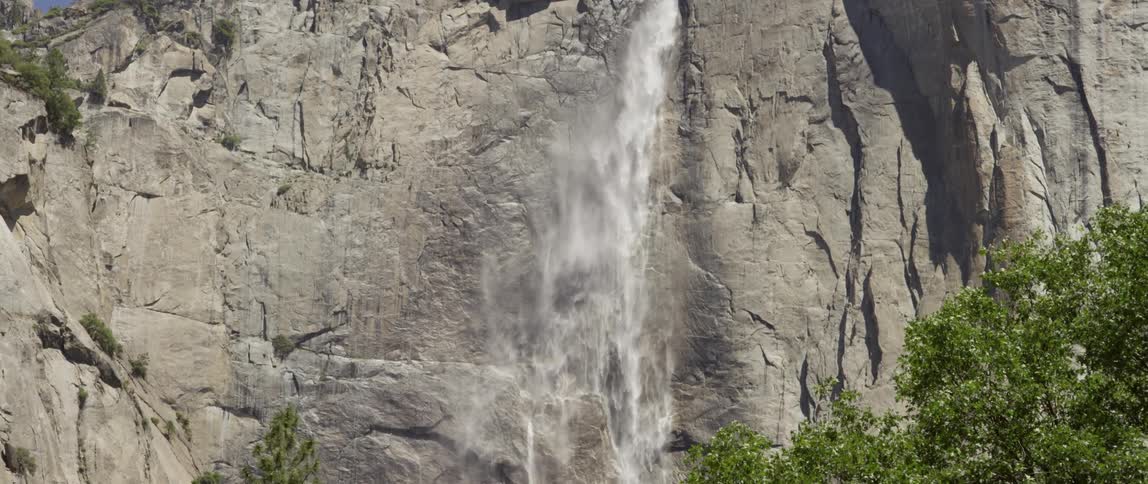 A waterfall cascades over a cliff