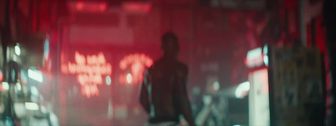A man walks around in the dark gym after exercising