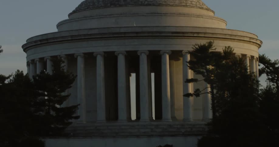 The jefferson memorial is shown at sunset