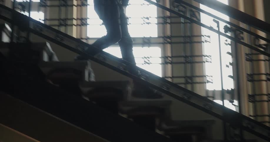 A person rushes down the steps