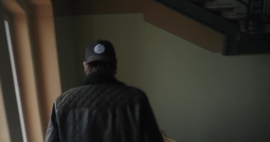 A man walks down some stairs in a building