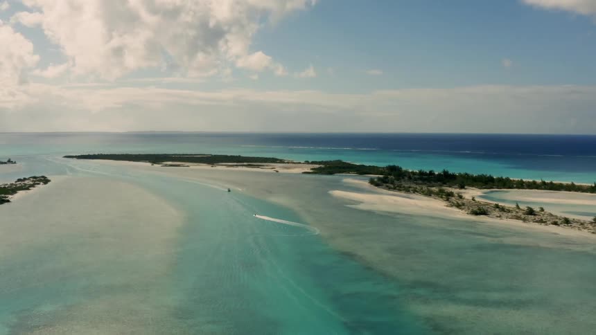 A boat leaves a wake in a tropical ocean