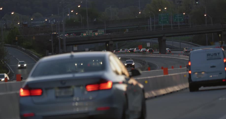Cars drive on a freeway at sunset