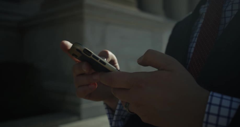 A man uses his phone outside