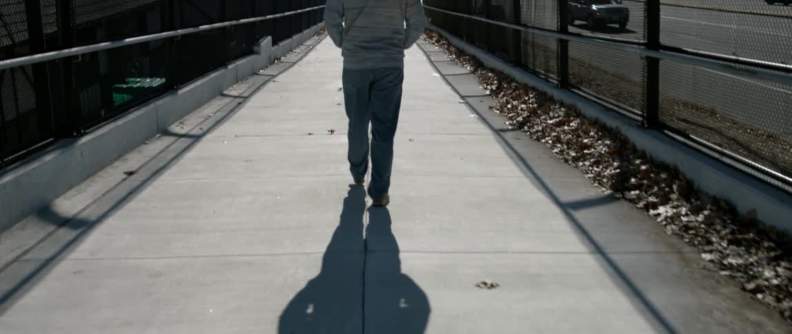 A person is walking on the overpass
