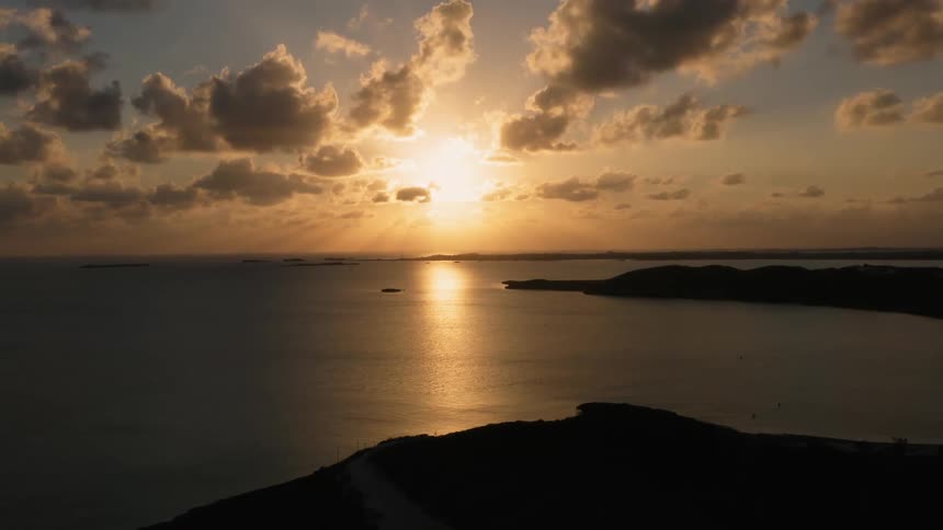Sun rises over a large body of water