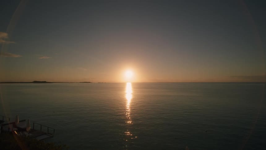 The sun shines on the flowing blue water
