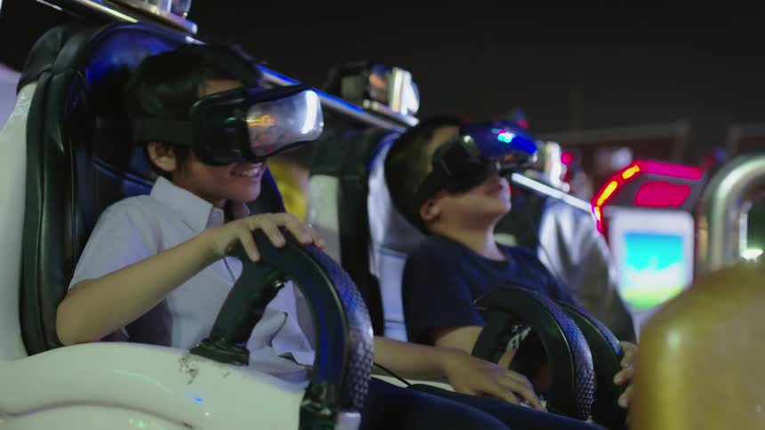 Two children have fun on a virtual reality ride