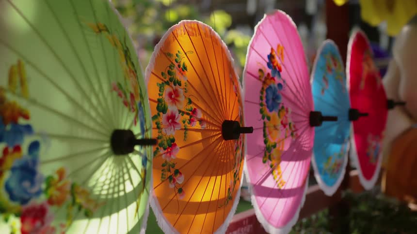 A row of colorful umbrellas are lined up