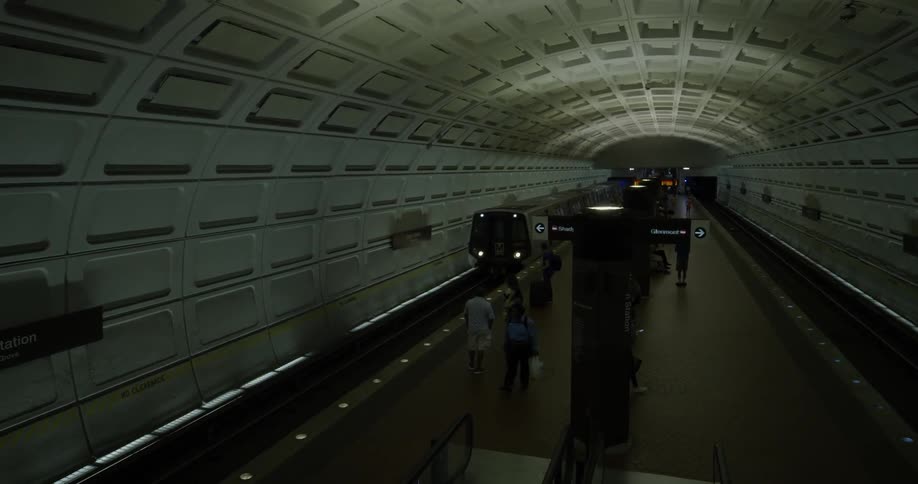A train enters the subway with waiting people