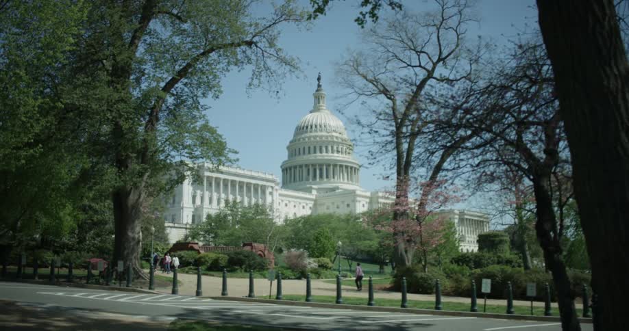 People walk on the grounds of the capitol building