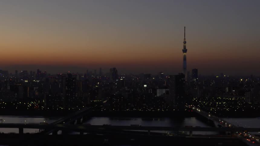 Sun sets over a river and large city