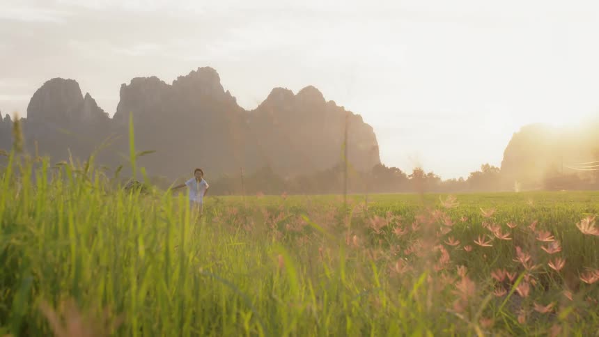A person is running through the flowers on a field