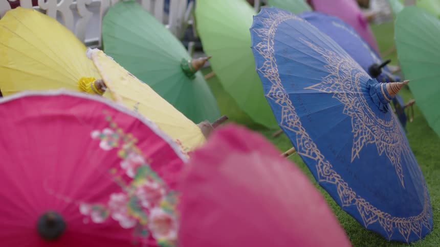 Multi colored umbrellas sit on the hill