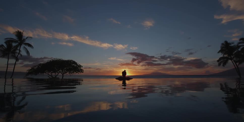 Lone person on the water as the sun sets