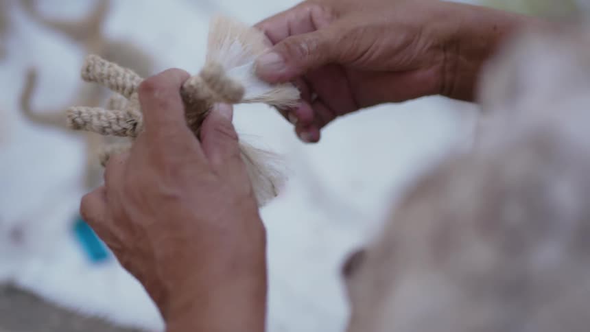 A person is wiping paint on a figure