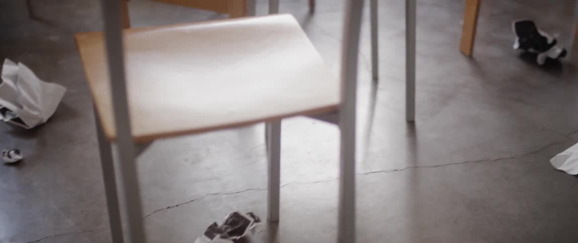 Crumpled up paper sits on the classroom floor