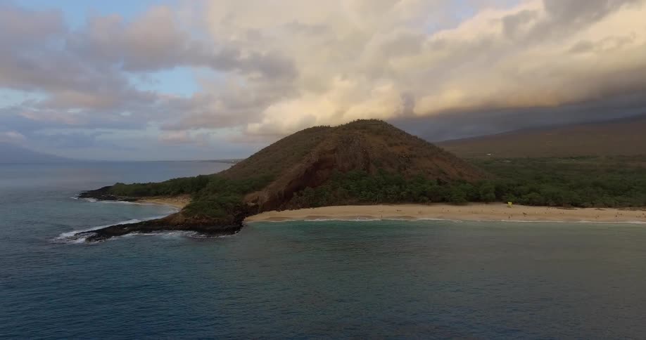 The island ahead is surrounded by calm water and sand